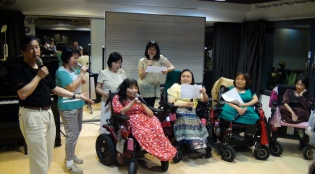 Mr Chu teaches the wheelchair users a cappella skills