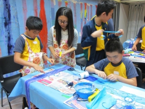 Participants creating artwork under guidance